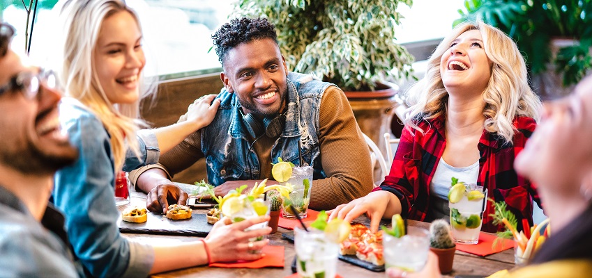 A group of young people eating at a restaurant