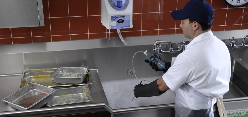 Restaurant employee near kitchen sink