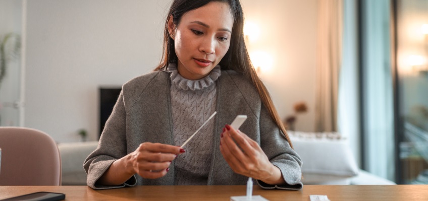 Woman holding a COVID-19 test