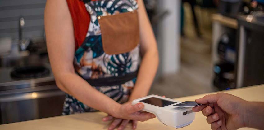 Restaurant employee processing a credit card payment