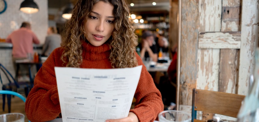 Woman reading over a menu