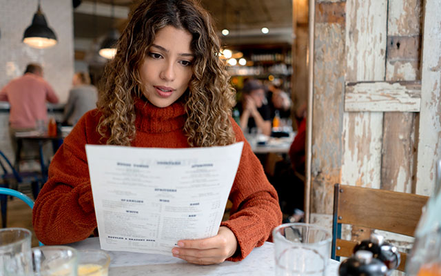 Woman reading menu - Menu Labeling
